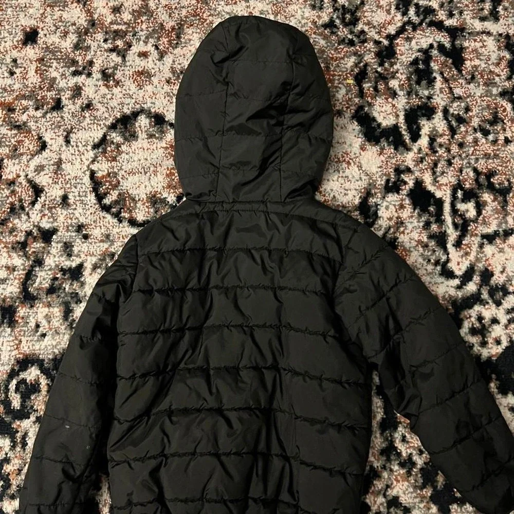 Nike black puffer jacket with red accents, size XS